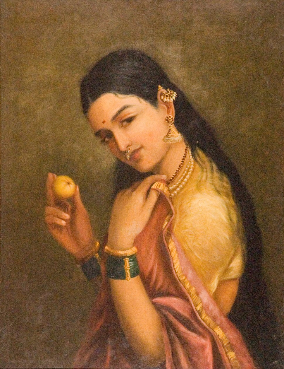 Nainen pitelee hedelmää tekijältä Raja Ravi Varma