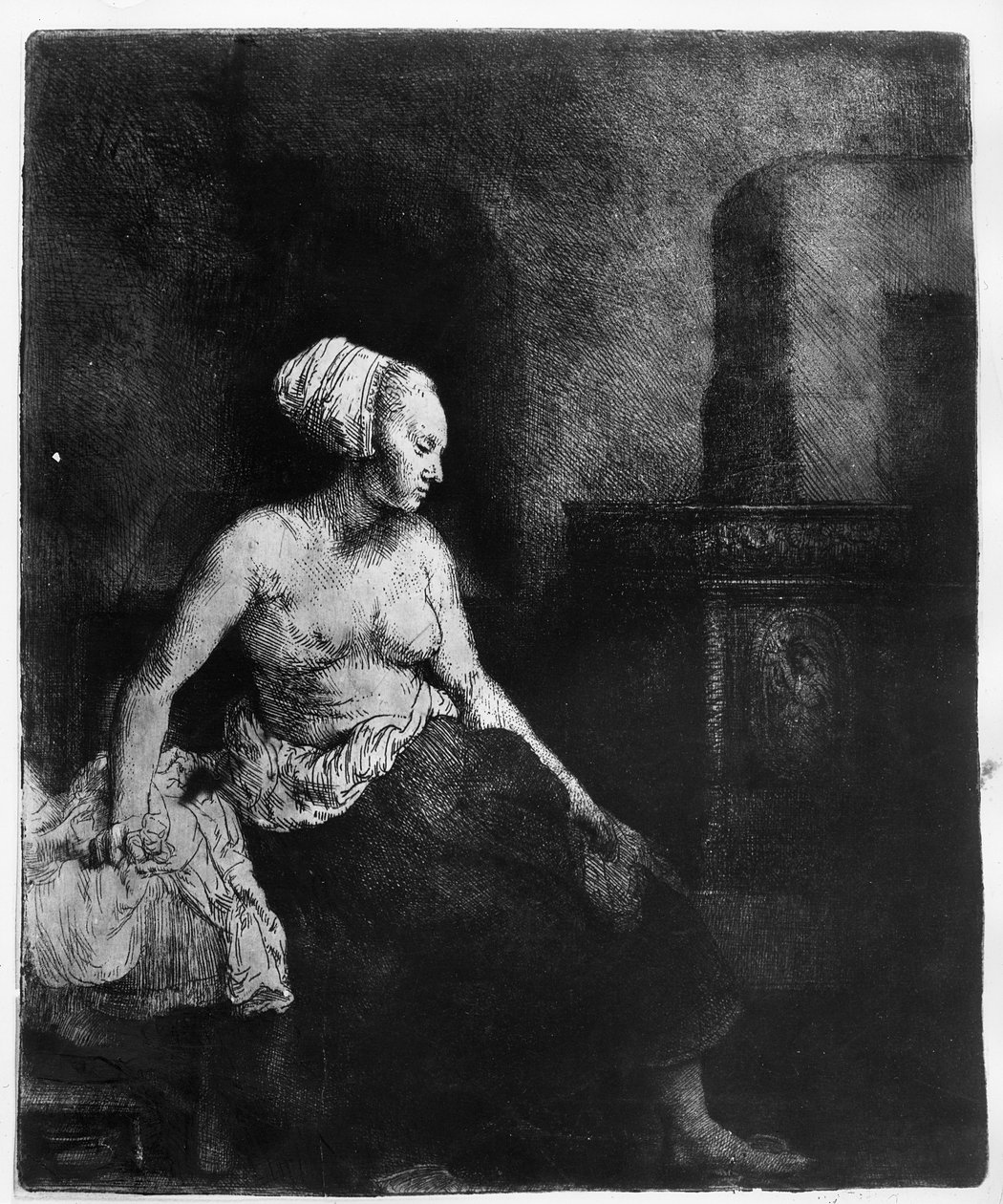 Nainen istuu puolipukeutuneena lieden vieressä, 1658 tekijältä Rembrandt van Rijn