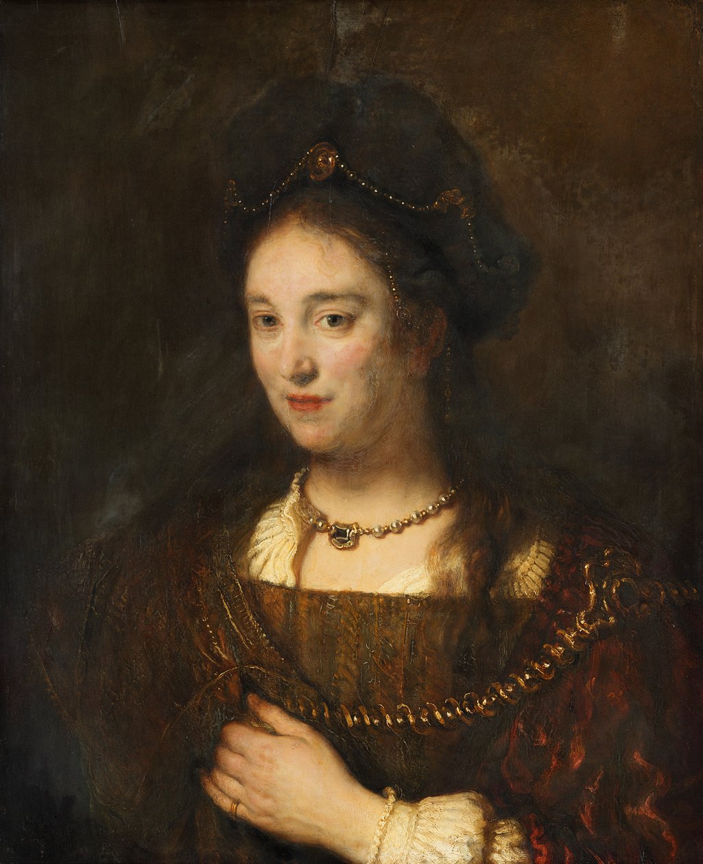 Naisen puolihahmo, jolla on baretti tekijältä Rembrandt