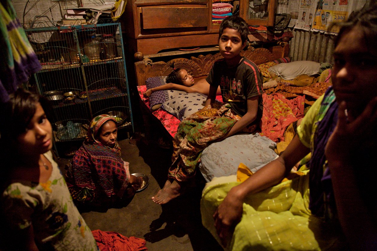 Perhe bambuslummitalossa lähellä Buriganga-jokea vanhassa Dhakassa, Bangladeshissa. 21. helmikuuta 2007. Jopa 6-10 ihmistä asuu 10 jalan x 10 jalan kokoisissa huoneissa, ja he jakavat yhteisen käsipumpun, wc:n ja keittiön. Suurin osa ihmisistä, jotka asuva tekijältä Unbekannt Unbekannt